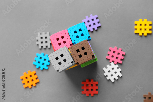 Child is playing with multi-colored blocks