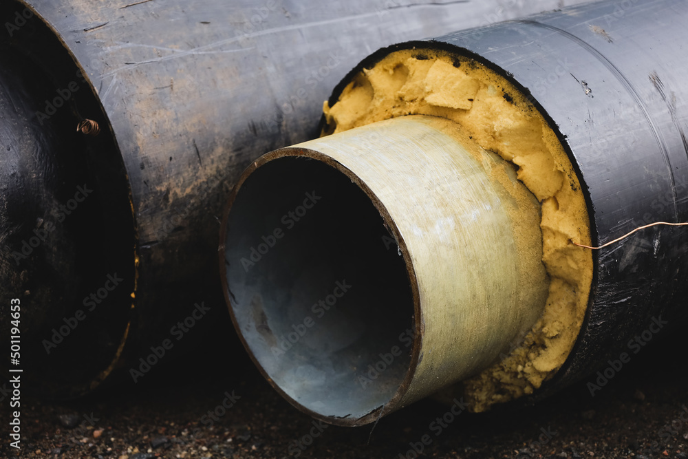 Pre-insulated pipe. Steel pipe with an upper layer of polyurethane foam insulation. Thermal insulation. Modern pipeline for supplying hot water and heating to a residential area. Industrial concept Pre-insulated pipe. Steel pipe with an upper layer of polyurethane foam insulation. Thermal insulation. Modern pipeline for supplying hot water and heating to a residential area. Industrial concept
