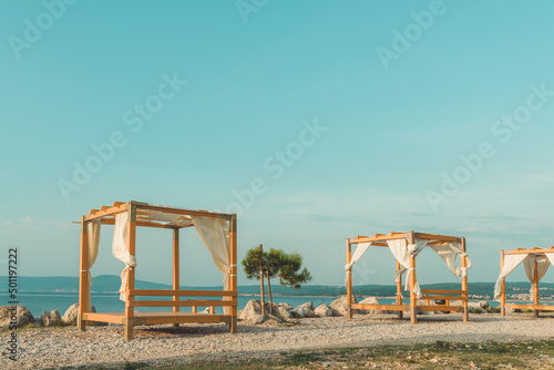 Beach pergola at seaside in summer morning photo