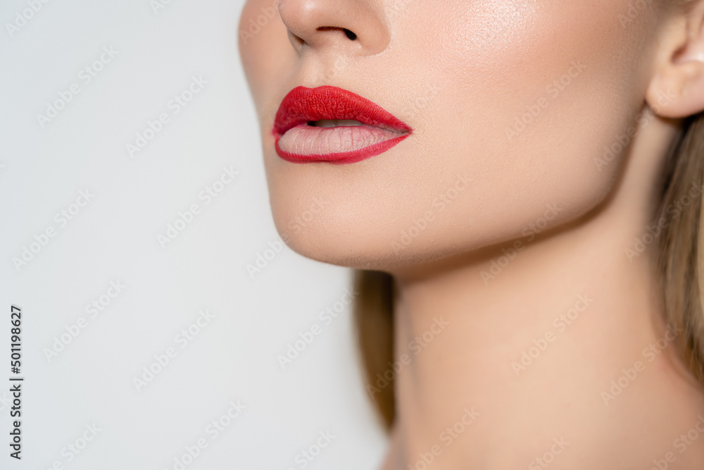 Cropped view of woman with red lips isolated on grey. Cropped view of woman with red lips isolated on grey.