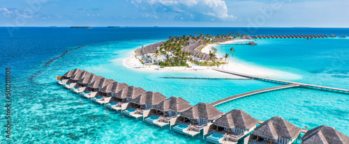 Beautiful Maldives paradise. Tropical aerial travel landscape, seascape with wooden bridge, water villas, amazing sea sand sky beach, tropical island nature. Exotic tourism destination summer vacation