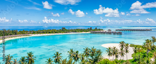 Beautiful Maldives paradise. Tropical aerial travel landscape, seascape with wooden bridge, water villas, amazing sea sand sky beach, tropical island nature. Exotic tourism destination summer vacation