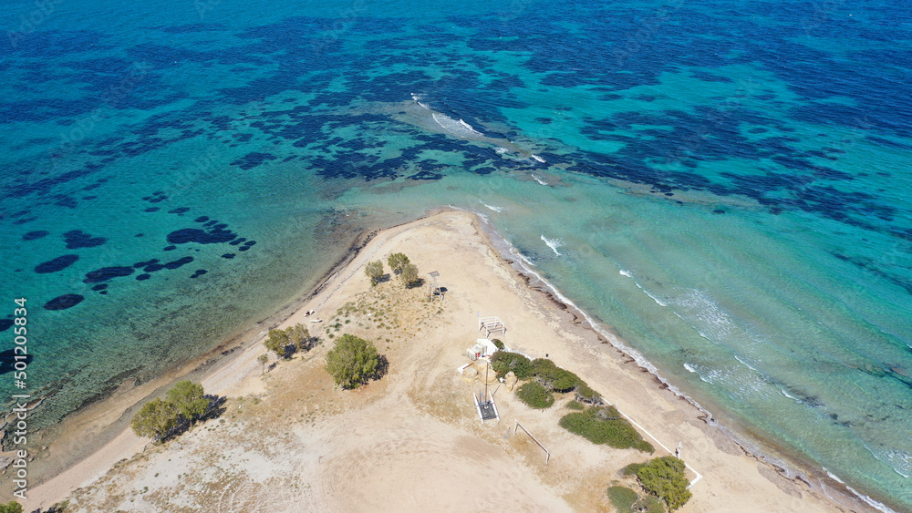 Aerial drone photo of tropical exotic paradise island bay with deep turquoise sea forming a blue lagoon visited by luxury yachts and sail boats Aerial drone photo of tropical exotic paradise island bay with deep turquoise sea forming a blue lagoon visited by luxury yachts and sail boats