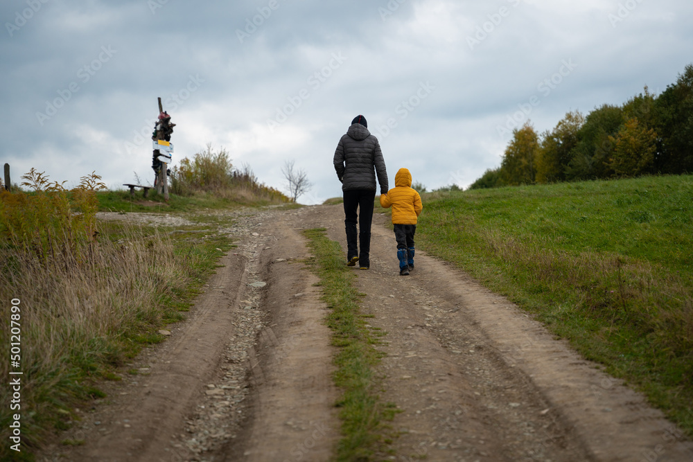 During the autumn, my mother and her little son go on a mountain trail. During the autumn, my mother and her little son go on a mountain trail.