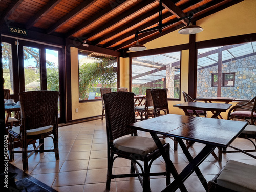 Simple restaurant interior with wooden tables and chairs