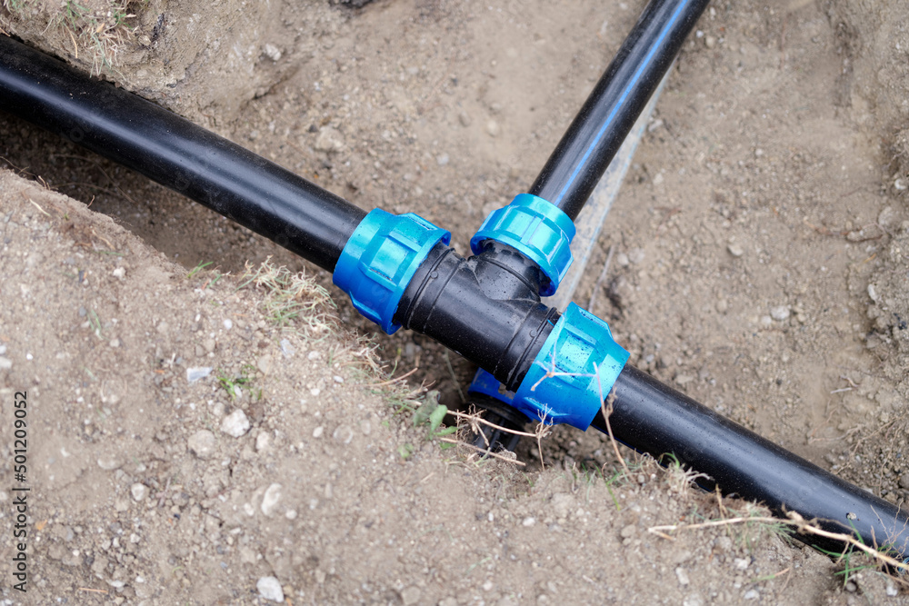 Equipment for automatic watering soil pipes lying in ground closeup