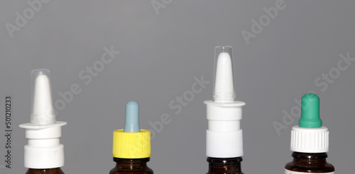 four bottles of sprays and a nasal drop