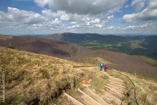 Fototapeta Naklejka Na Ścianę i Meble -  Spring in the Bieszczady Mountains, tourists descending mount Wielka Rawka, Poland