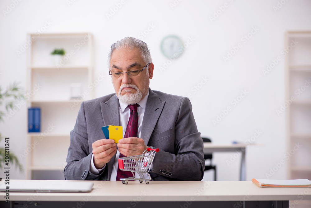 Young male employee in e-commerce concept Young male employee in e-commerce concept