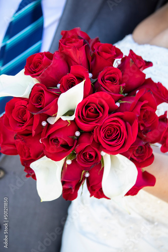 Beautiful Wedding Bouquet Made of Red Roses, White Calla Lilies, and Pearls