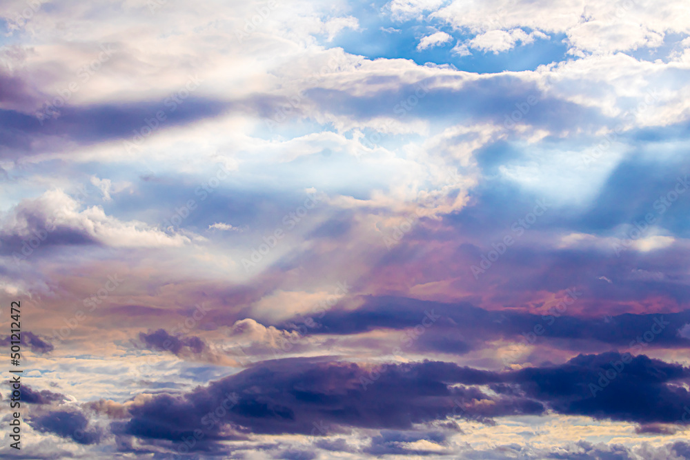 Obraz premium Sunlight Breaks through the Clouds and Turns Them Pink and Purple in Lafitte, Louisiana, USA