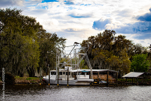 Personal Fishing Boat Is Parked at a Small Wooden Dock in the Town of Lafitte, Louisiana, USA
