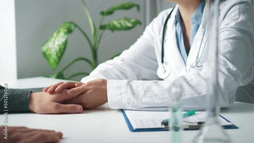 doctor pediatrician holds the patient by the hand calming him. The ...