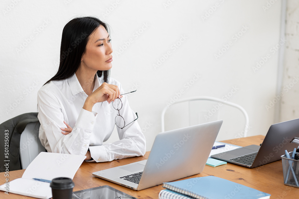 Asian woman working on her laptop in the office. Concept of businesswoman, female using technology, notebook, job in corporation, young professionals. Copy space for text