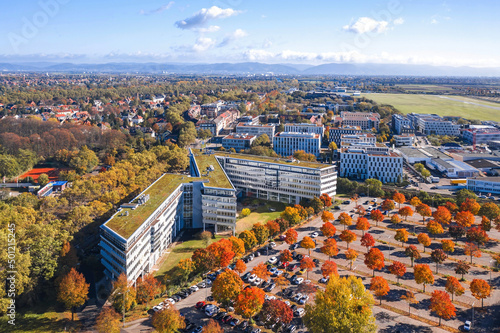Obraz na płótnie Mannheim cityscape, Germany. Autumn aerial view over office center, car parking and Park at technology museum in Fahrlach district, city airport on the background. w salonie