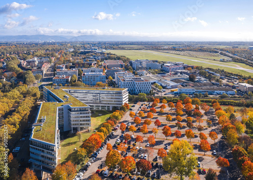 Obraz na płótnie Mannheim cityscape, Germany. Autumn aerial view over office center, car parking and Park at technology museum in Fahrlach district, city airport on the background. w salonie