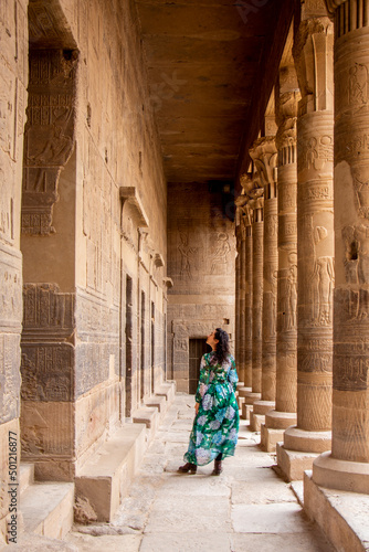 Woman between Pillars of Philae Temple, Aswan, Egypt