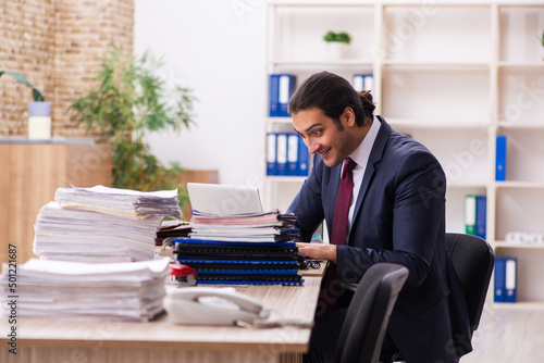 Fényképezés Young male employee unhappy with excessive work