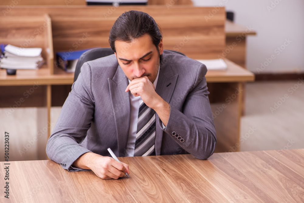 Young businessman employee sitting in the office Young businessman employee sitting in the office