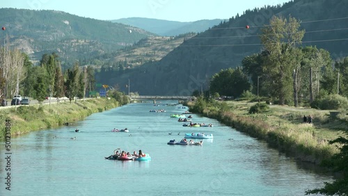 Penticton, British Columbia, Canada – July 20, 2019 Penticton River Channel Floating in Summer 4K UHD. People drifting down the Penticton Channel in summer. British Columbia, Canada. 4K, UHD.

 photo