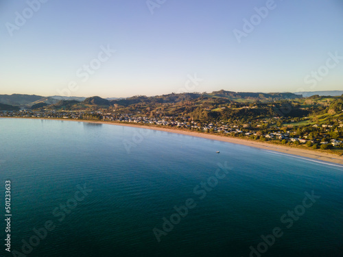 Sunrise over Cooks Beach coastline along the Coromandel Peninsula in New Zealand's North Island.