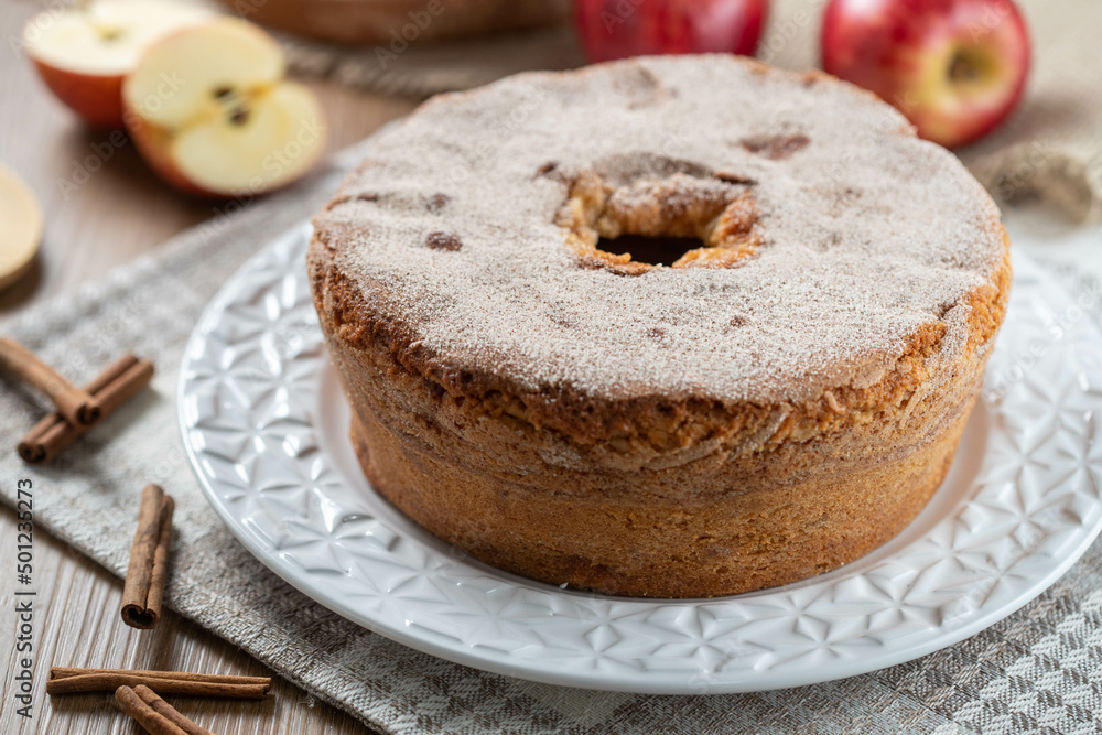 Sponge cake or chiffon cake with apples so soft and delicious sliced ​​with ingredients: cinnamon, eggs, flour, apples on wooden table. Home bakery concept for background and wallpaper