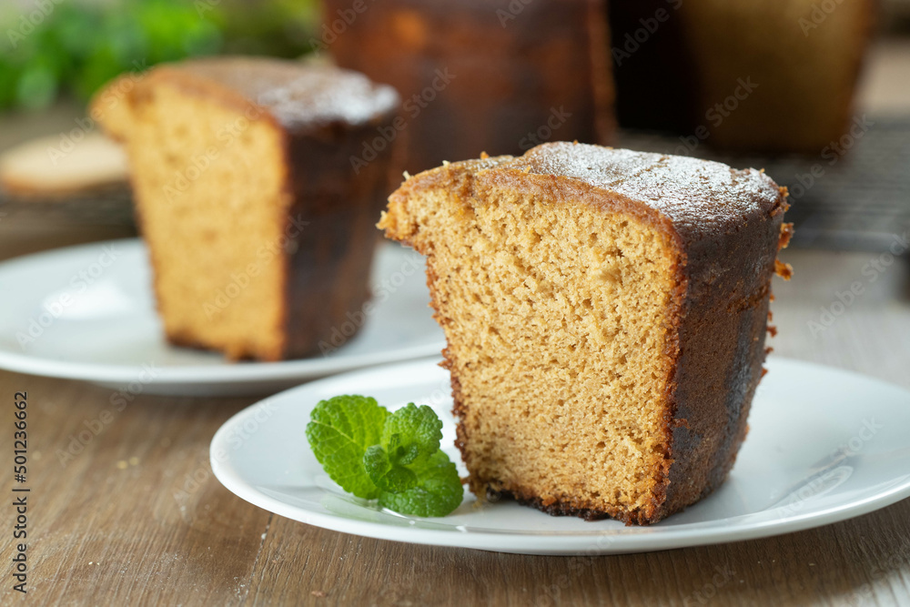 Close up piece of Brazilian corn cake made with a type of corn flour (Fuba). On a wooden party table. Typical sweets of the June festival. Cornmeal cake