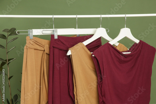 Display of casual clothes made of organic cotton on clothing rack in fashion studio.