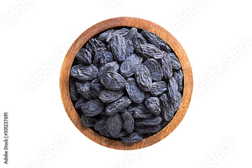 blue raisins, dried grapes in wooden bowl isolated on white background. Vegan food, top view.