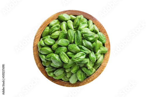 pistachios nuts peeled green in wooden bowl isolated on white background. Vegan food, top view.