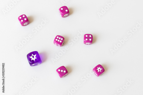 Six random violet and one big blue dice on a white isolated background