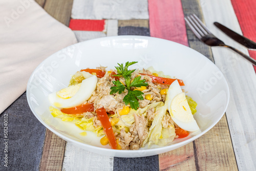 Tuna and vegetable salad on white bowl