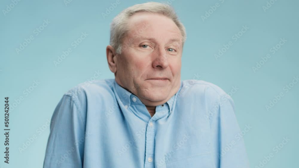 Puzzled senior man shrugging shoulders and shaking head in rejection, expressing nescience and unconfidence
