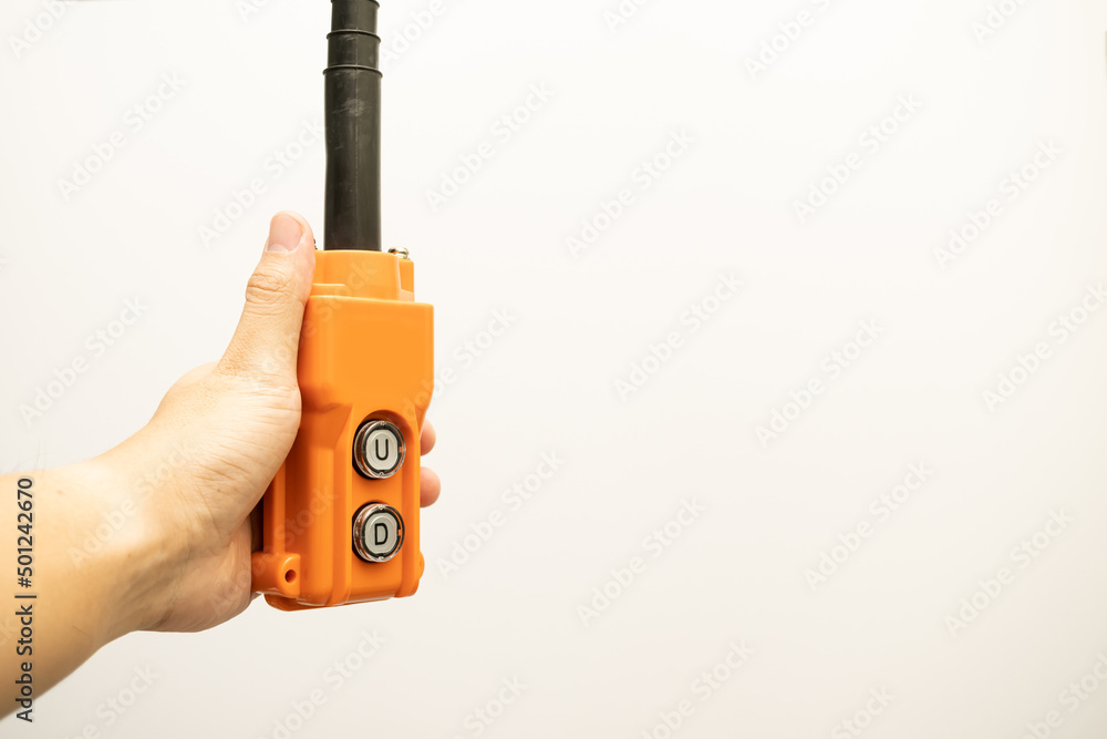 Hoist push button switch in isolated. hand holding overhead cranes ...