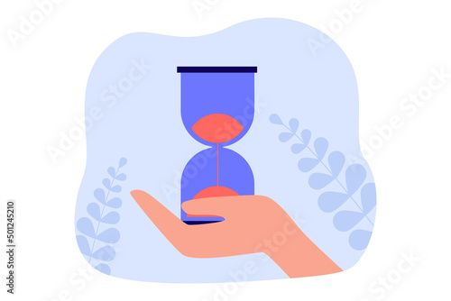 Hand holding hourglass with sand flowing down. Person counting time with sandglass flat vector illustration. Countdown, deadline, patience concept for banner, website design or landing web page