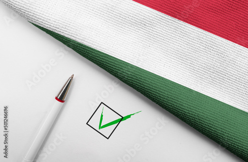 Pencil, Flag of Hungary and check mark on paper sheet  photo