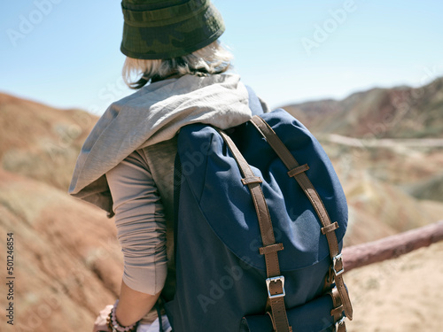 rear view of female asian tourist backpacker looking at view in national park