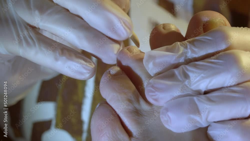 A closer look of the pedicure session at home getting off the dry skin on the toes A closer look of the pedicure session at home getting off the dry skin on the toes