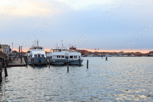 Townscape panorama of Chioggia with boats mooring at Venetian Lagoon in the evening in Veneto, Italy
