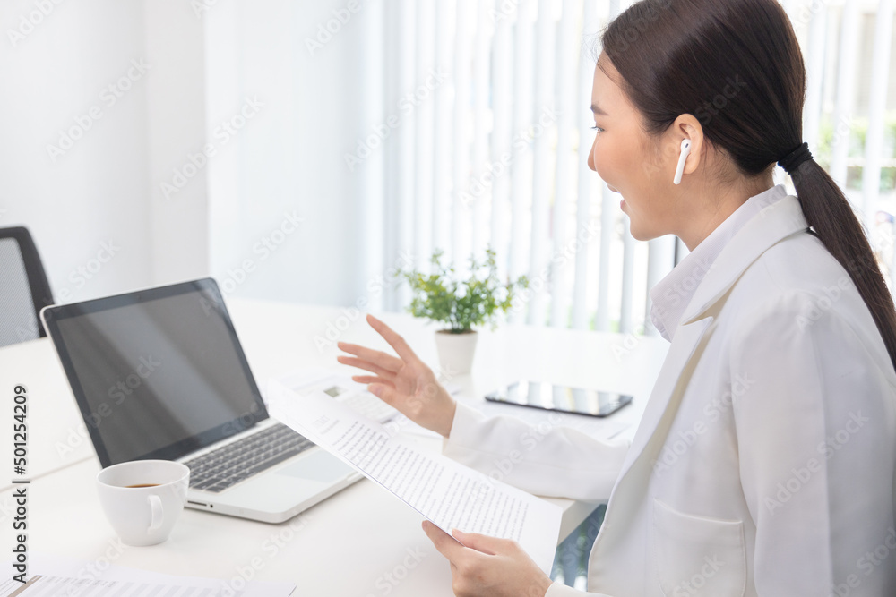 Young Asian women are talking friends and manager through video chats and greeting them with cheerful expressions, Online communication , Stay home, New normal, VDO Call, Internet working.