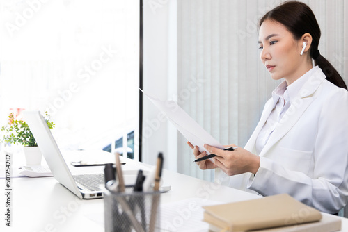 Business woman analyzing data graph in private office room, Presents Graph data and plan marketing strategies for executives who attend team meetings to analyze and develop for business.