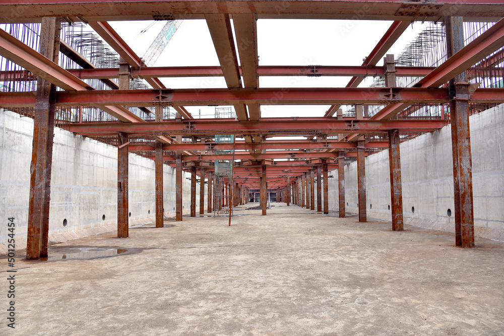 Reinforced steel frame structure under the construction building with steel piles screwed into the ground. Industrial concept. Reinforced steel frame structure under the construction building with steel piles screwed into the ground. Industrial concept.
