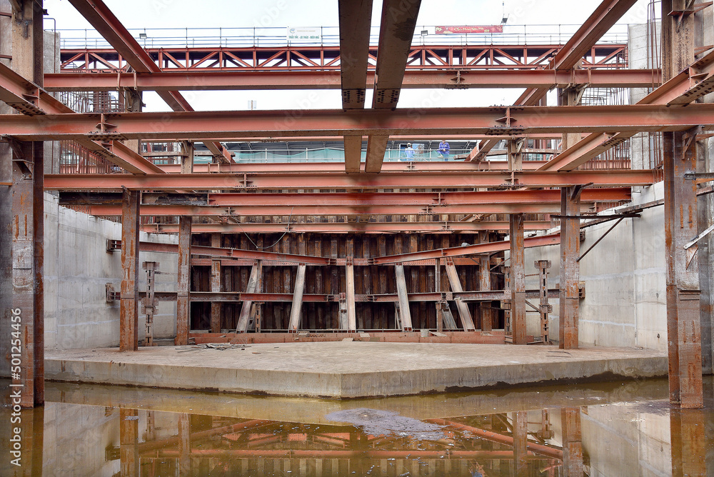 Reinforced steel frame structure under the construction building with steel piles screwed into the ground. Industrial concept. Reinforced steel frame structure under the construction building with steel piles screwed into the ground. Industrial concept.