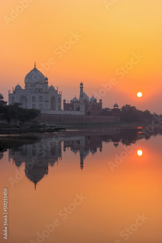 Taj Mahal reflected in Yamuna river at sunset in Agra, India