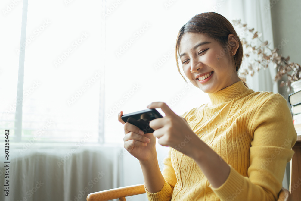 Asian woman excited while playing mobile games, reading good news while surfing the internet world. Asian woman excited while playing mobile games, reading good news while surfing the internet world.