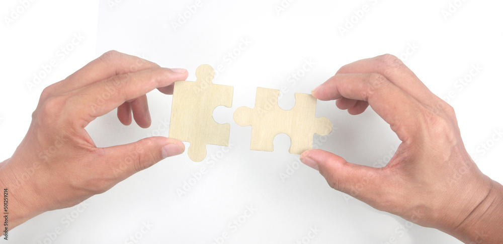 Connecting jigsaw puzzle in hand Connecting jigsaw puzzle in hand