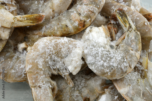 Freezer burned shrimp  in the shell coated with ice crystals from improper packaging or refrigeration