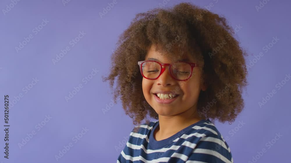 Studio Shot Of Smiling Boy Wearing Red Glasses Against Purple Background Studio Shot Of Smiling Boy Wearing Red Glasses Against Purple Background