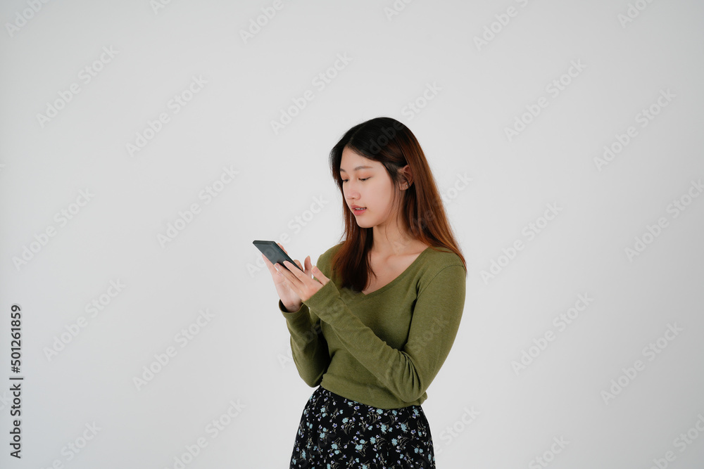 Portrait of young asian woman is calling on mobile phone, Attractive of Asian Woman is Talking on Her Smartphone and Smiling While Communicating on white background.