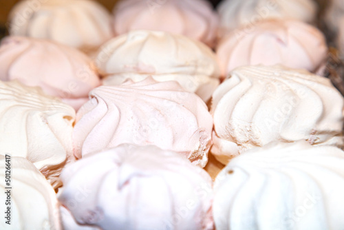 Several white and pink marshmallows, close-up.